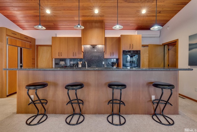 572 Rockrose Ct, Incline Village, NV 89451 - kitchen featuring black oven, wooden ceiling, paneled built in refrigerator, a wall mounted air conditioner, and light colored carpet