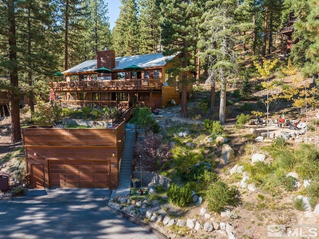 572 Rockrose Ct, Incline Village, NV 89451 - rustic home featuring a wooden deck, a detached garage, and a view of trees