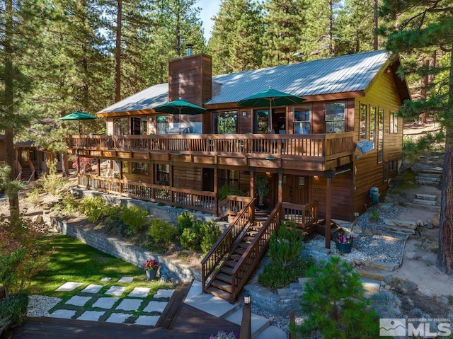 572 Rockrose Ct, Incline Village, NV 89451 - back of property featuring stairs, a wooden deck, a chimney, and metal roof