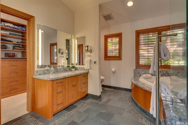 572 Rockrose Ct, Incline Village, NV 89451 - full bath featuring vanity, inlaid floor details, baseboards, vaulted ceiling, and toilet