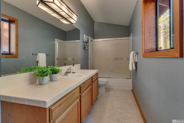 572 Rockrose Ct, Incline Village, NV 89451 - full bathroom featuring vanity, toilet, baseboards, shower / bath combination with glass door, and vaulted ceiling