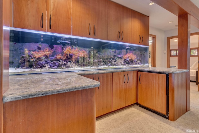 572 Rockrose Ct, Incline Village, NV 89451 - kitchen with light carpet, recessed lighting, stone countertops, and brown cabinetry