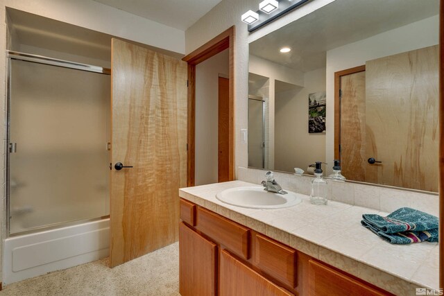 572 Rockrose Ct, Incline Village, NV 89451 - full bathroom with vanity, shower / bath combination with glass door, and recessed lighting