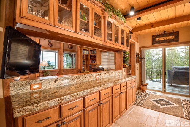 1101 Sierra Country Ct, Gardnerville, NV 89460 - kitchen featuring wood ceiling, stone tile flooring, beam ceiling, healthy amount of natural light, and light stone counters