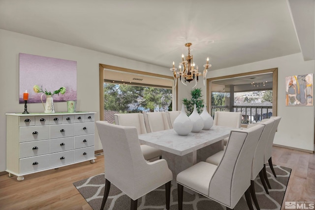2570 Spinnaker Dr, Reno, NV 89519 - dining space with a chandelier and light wood-style floors