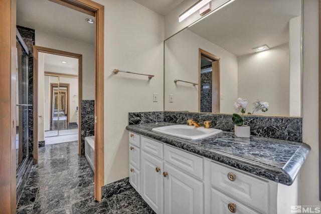 2570 Spinnaker Dr, Reno, NV 89519 - full bathroom with marble look tile flooring, vanity, a stall shower, and a tub