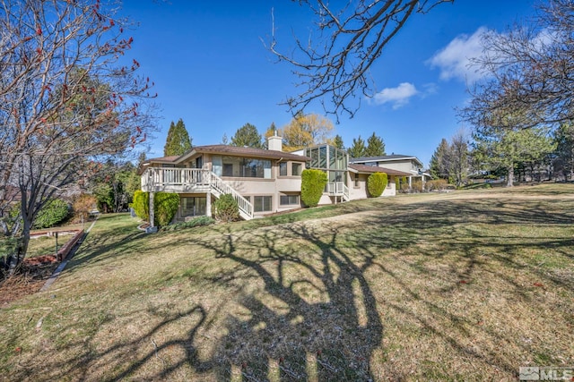 2570 Spinnaker Dr, Reno, NV 89519 - back of property with stairs, a chimney, a yard, a wooden deck, and stucco siding
