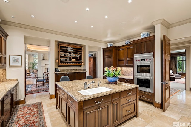 6025 Lake Geneva, Reno, NV 89511 - kitchen with a sink, ornamental molding, stainless steel double oven, a kitchen island with sink, and decorative backsplash