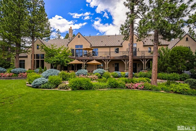 6025 Lake Geneva, Reno, NV 89511 - back of house with stucco siding, a lawn, a chimney, and a tiled roof