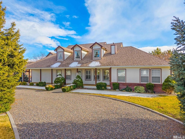 1973 Arabian Ln, Gardnerville, NV 89410 - cape cod-style house featuring brick siding, a porch, and roof with shingles