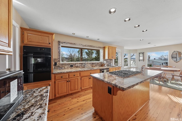 1973 Arabian Ln, Gardnerville, NV 89410 - kitchen with stainless steel gas stovetop, a sink, a center island, plenty of natural light, and recessed lighting
