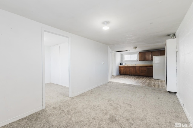 134 E 6th St, Battle Mountain, NV 89820 - unfurnished living room with light colored carpet and baseboards