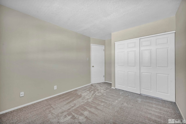 435 Pine Meadows Dr # 33, Sparks, NV 89431 - unfurnished bedroom featuring baseboards, a textured ceiling, carpet flooring, and a closet