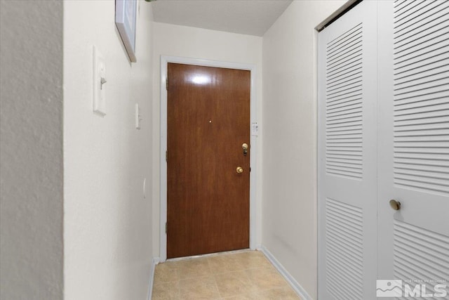 3230 Downey Ave, Reno, NV 89503 - doorway to outside featuring baseboards and light tile patterned flooring