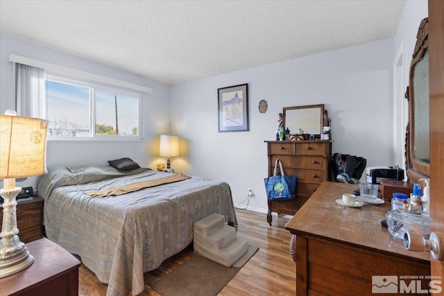 3230 Downey Ave, Reno, NV 89503 - bedroom featuring light wood finished floors, a textured ceiling, and baseboards