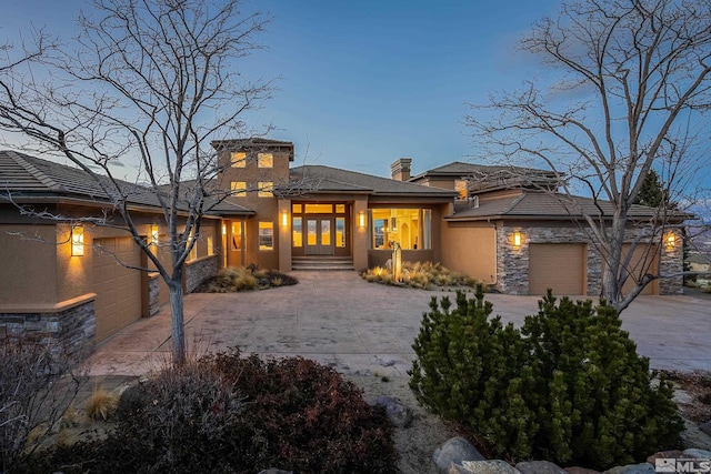3605 Silver Vista Dr, Reno, NV 89511 - view of front of home featuring concrete driveway, stone siding, an attached garage, and stucco siding