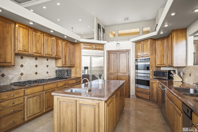 3605 Silver Vista Dr, Reno, NV 89511 - kitchen with a sink, stainless steel appliances, brown cabinetry, an island with sink, and recessed lighting