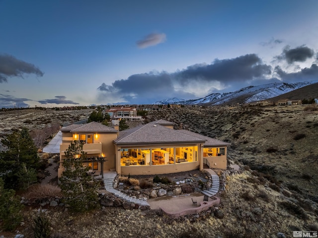 3605 Silver Vista Dr, Reno, NV 89511 - rear view of property featuring a mountain view, a patio, and stucco siding