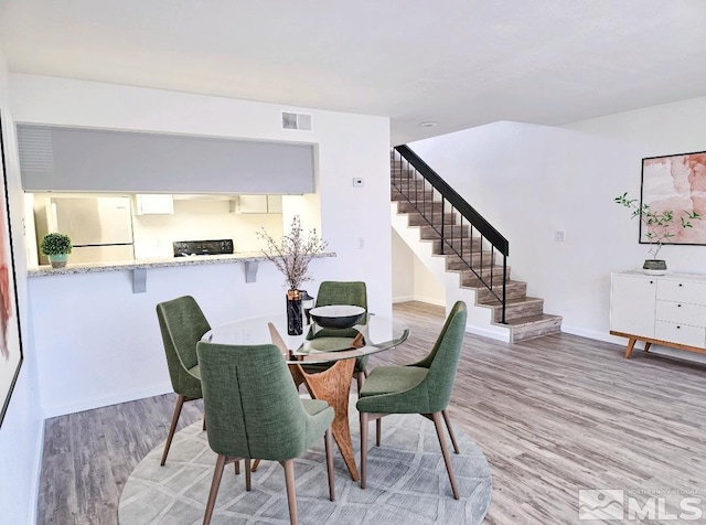 1023 Adrian Way, Sparks, NV 89431 - dining room with stairs, light wood finished floors, and baseboards