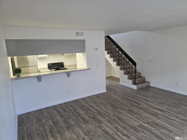 1023 Adrian Way, Sparks, NV 89431 - unfurnished living room with dark wood-style flooring, stairs, and baseboards