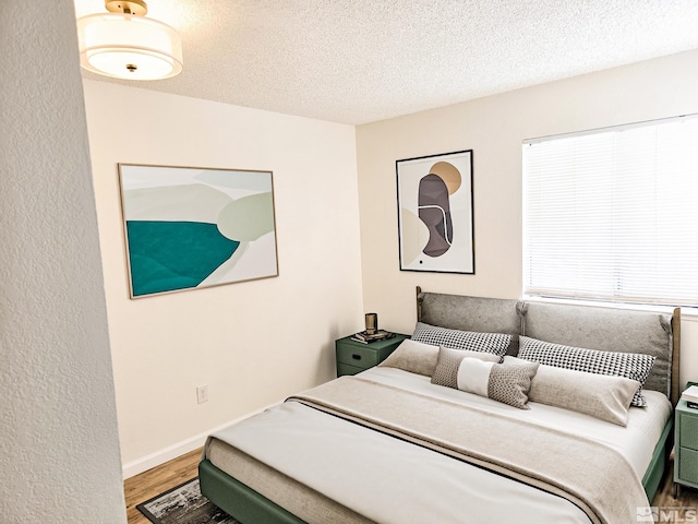 1023 Adrian Way, Sparks, NV 89431 - bedroom with wood finished floors, a textured ceiling, and baseboards