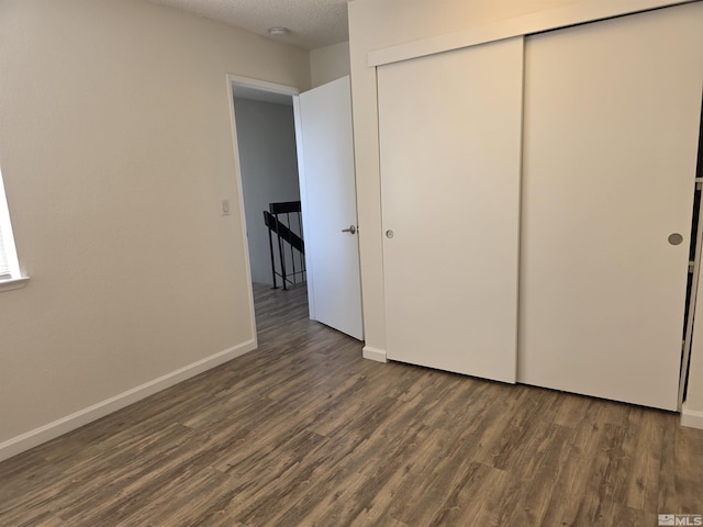 1023 Adrian Way, Sparks, NV 89431 - unfurnished bedroom featuring wood finished floors, a closet, baseboards, and a textured ceiling