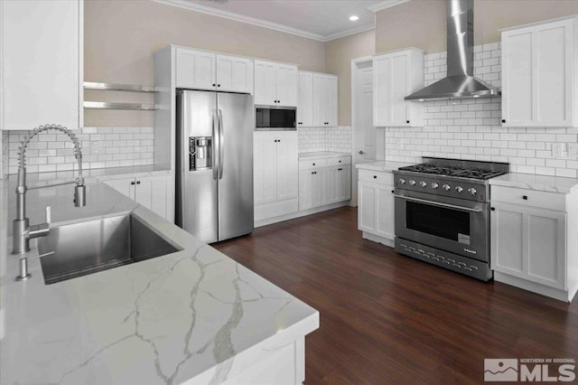 6141 Solstice Dr, Sparks, NV 89436 - kitchen with appliances with stainless steel finishes, wall chimney range hood, a sink, ornamental molding, and backsplash