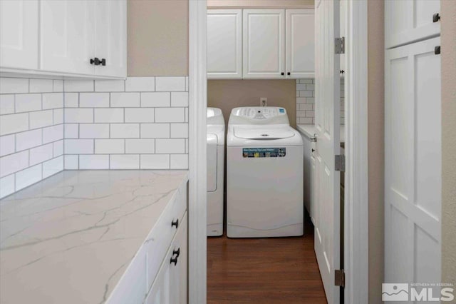 6141 Solstice Dr, Sparks, NV 89436 - laundry area featuring washing machine and dryer, cabinet space, and dark wood-style flooring