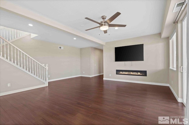 6141 Solstice Dr, Sparks, NV 89436 - unfurnished living room featuring a glass covered fireplace, a ceiling fan, stairway, wood finished floors, and baseboards