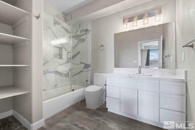 6141 Solstice Dr, Sparks, NV 89436 - bathroom featuring toilet, a textured wall, vanity, and combined bath / shower with glass door
