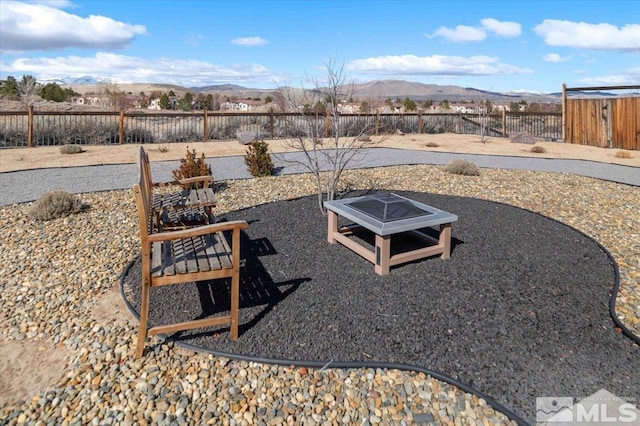 6141 Solstice Dr, Sparks, NV 89436 - fenced backyard featuring a mountain view and an outdoor fire pit