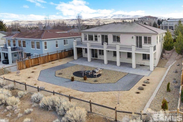 6141 Solstice Dr, Sparks, NV 89436 - back of property with a patio, stucco siding, a fenced backyard, a balcony, and a residential view