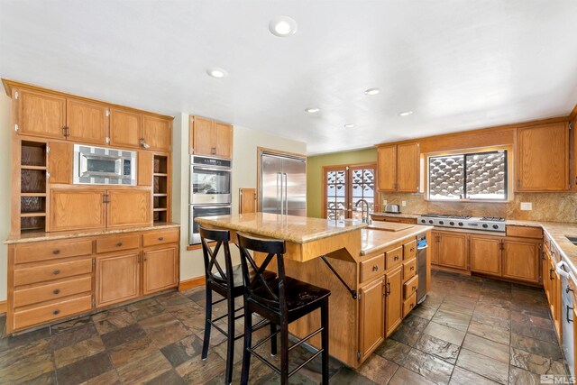 626 Canyon Dr, Zephyr Cove, NV 89448 - kitchen featuring built in appliances, stone tile flooring, decorative backsplash, recessed lighting, and an island with sink