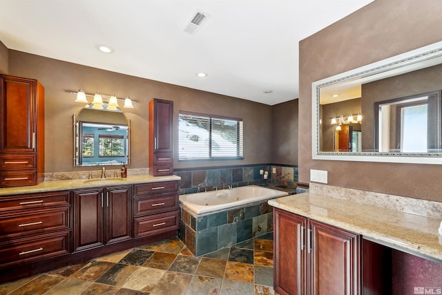 626 Canyon Dr, Zephyr Cove, NV 89448 - bathroom featuring stone tile floors, a tub with jets, vanity, and recessed lighting