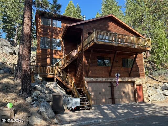 626 Canyon Dr, Zephyr Cove, NV 89448 - view of front facade featuring stairs, a garage, a wooden deck, and driveway