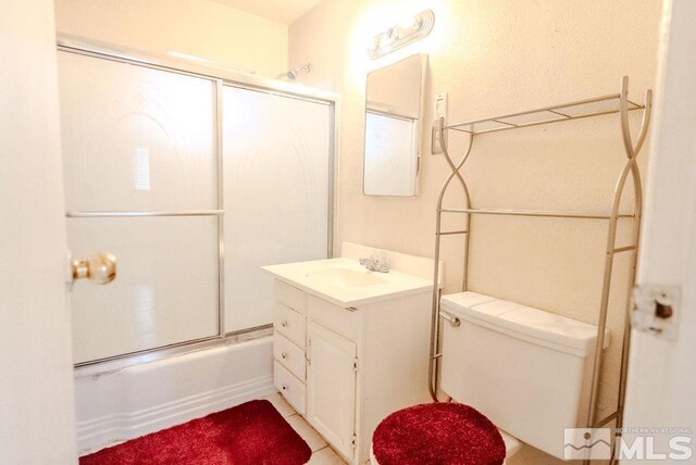 1845 Auburn Way, Reno, NV 89502 - bathroom with vanity, bath / shower combo with glass door, tile patterned floors, and toilet
