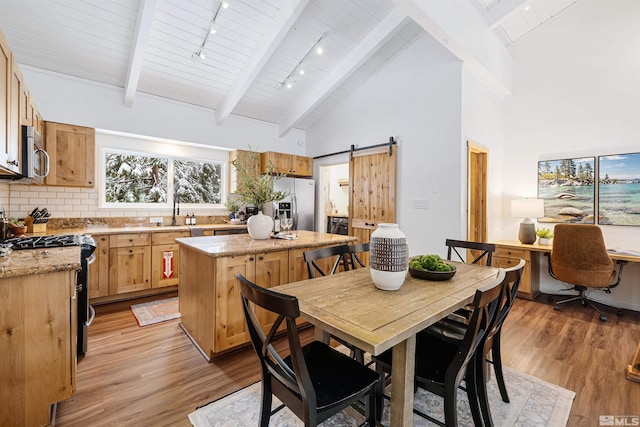 321 Ski Way Unit 29, Incline Village, NV 89451 - dining area featuring light wood-type flooring, beamed ceiling, high vaulted ceiling, an office area, and a barn door