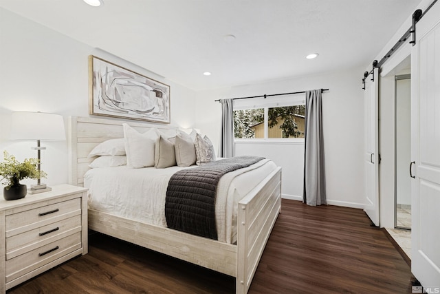 321 Ski Way Unit 29, Incline Village, NV 89451 - bedroom featuring a barn door, dark wood-style flooring, recessed lighting, and baseboards