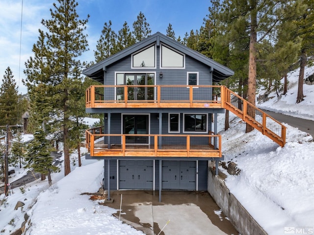 520 Laurel Ln, Stateline, NV 89449 - snow covered house with a garage, driveway, and a balcony