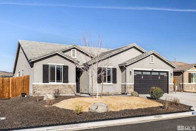 2183 Kingston Canyon Dr, Sparks, NV 89441 - ranch-style house featuring stone siding, fence, an attached garage, stucco siding, and driveway