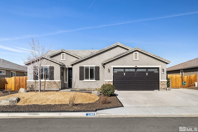 2183 Kingston Canyon Dr, Sparks, NV 89441 - single story home with stone siding, fence, an attached garage, and stucco siding