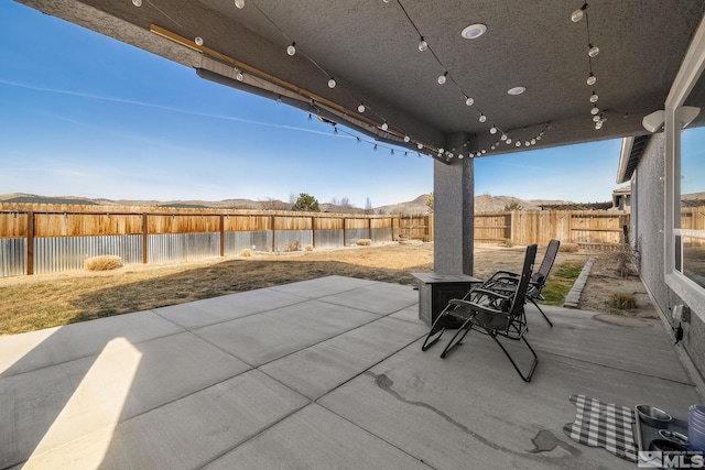 2183 Kingston Canyon Dr, Sparks, NV 89441 - view of patio featuring a fenced backyard and a water and mountain view