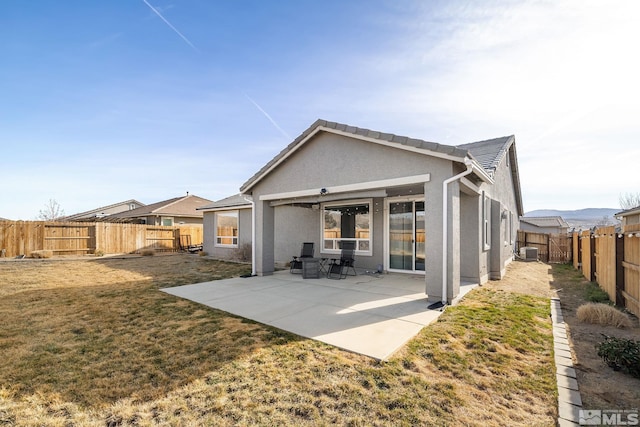 2183 Kingston Canyon Dr, Sparks, NV 89441 - rear view of house featuring stucco siding, a patio area, and central air condition unit