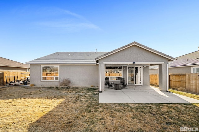 2183 Kingston Canyon Dr, Sparks, NV 89441 - rear view of property with stucco siding, a patio area, and a tile roof