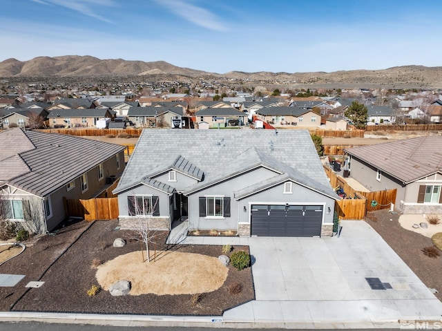 2183 Kingston Canyon Dr, Sparks, NV 89441 - view of front facade with a residential view, an attached garage, fence, and a mountain view