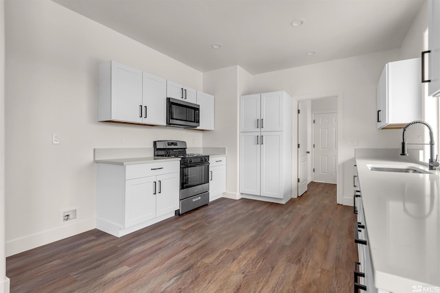 14485 N Red Rock Rd, Reno, NV 89508 - kitchen with stainless steel microwave, range with gas cooktop, a sink, dark wood finished floors, and baseboards