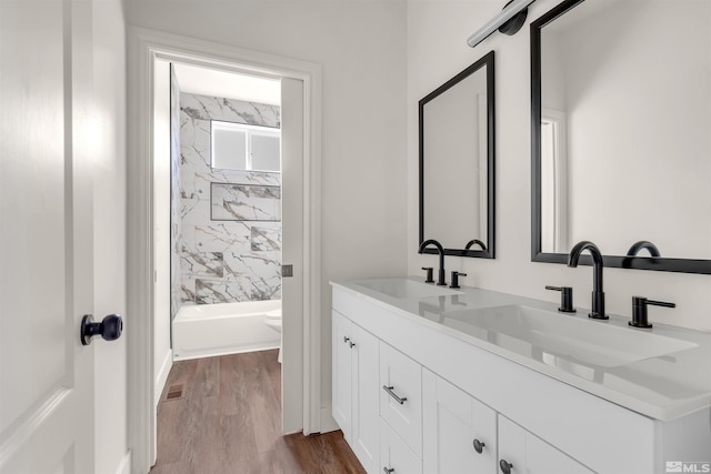 14485 N Red Rock Rd, Reno, NV 89508 - bathroom featuring double vanity, wood finished floors, toilet, and bathtub / shower combination