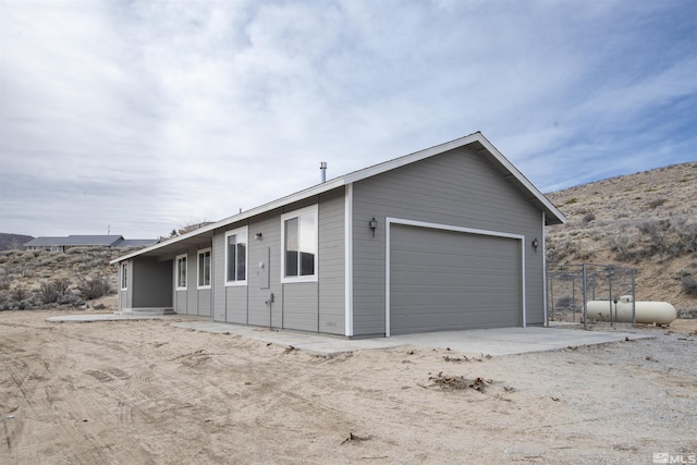 14485 N Red Rock Rd, Reno, NV 89508 - view of side of home with a garage and a mountain view