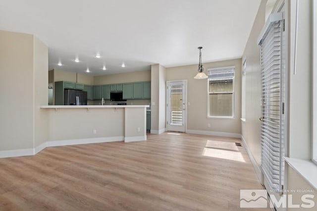 609 Caughlin, Reno, NV 89519 - unfurnished living room with baseboards, light wood finished floors, and a sink