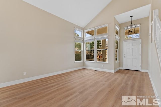 609 Caughlin, Reno, NV 89519 - foyer entrance featuring a chandelier, high vaulted ceiling, light wood-style flooring, and baseboards